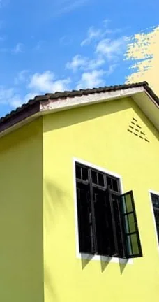 Outside of Homestay Benting Lintang, painted yellow with large windows